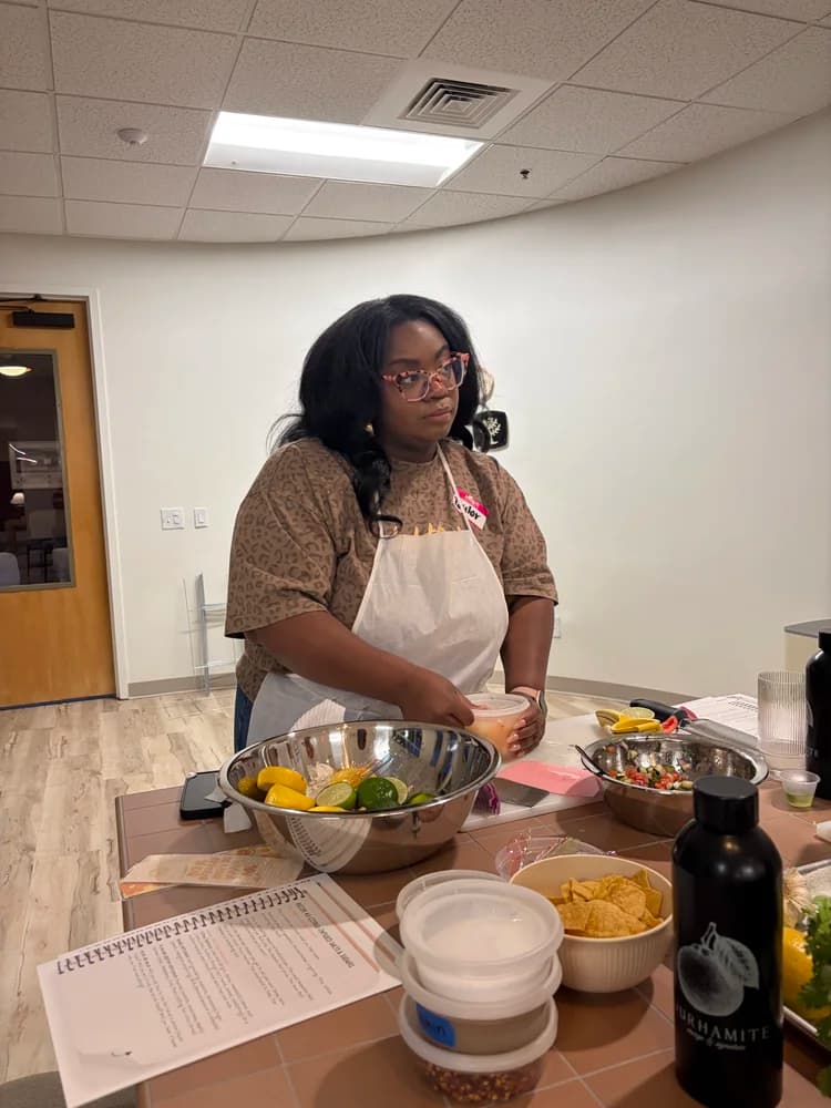 An adult participant works in the culinary classroom