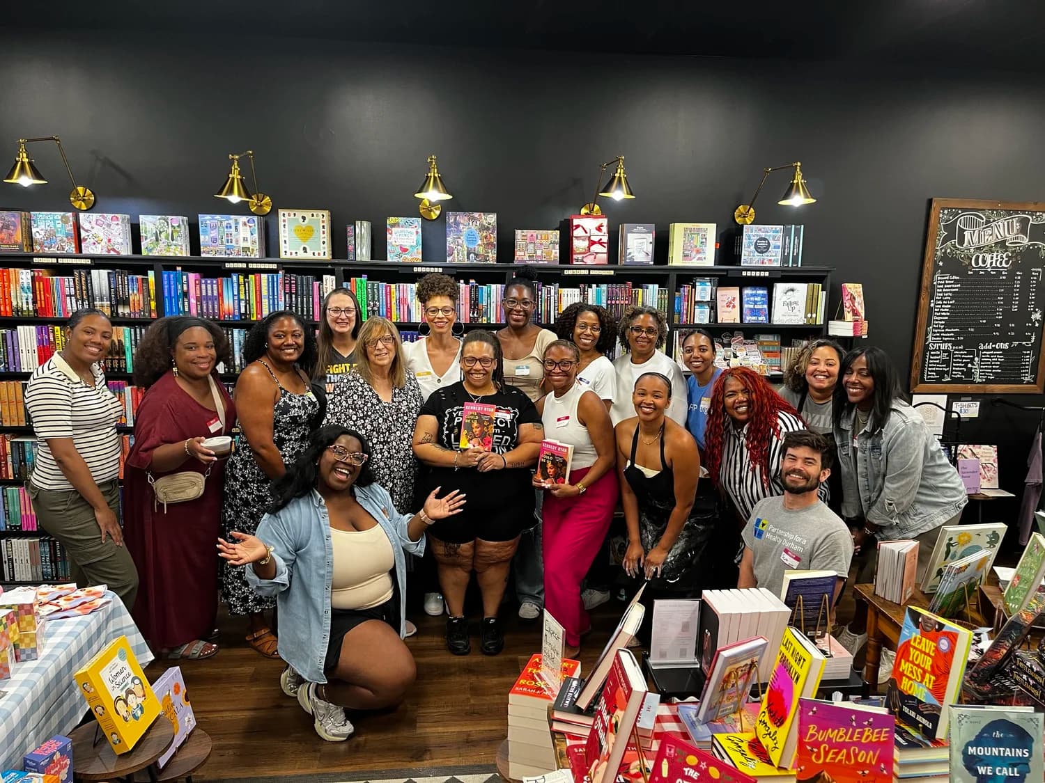 Kind Kitchen participants and partners gather together in a Durham bookstore