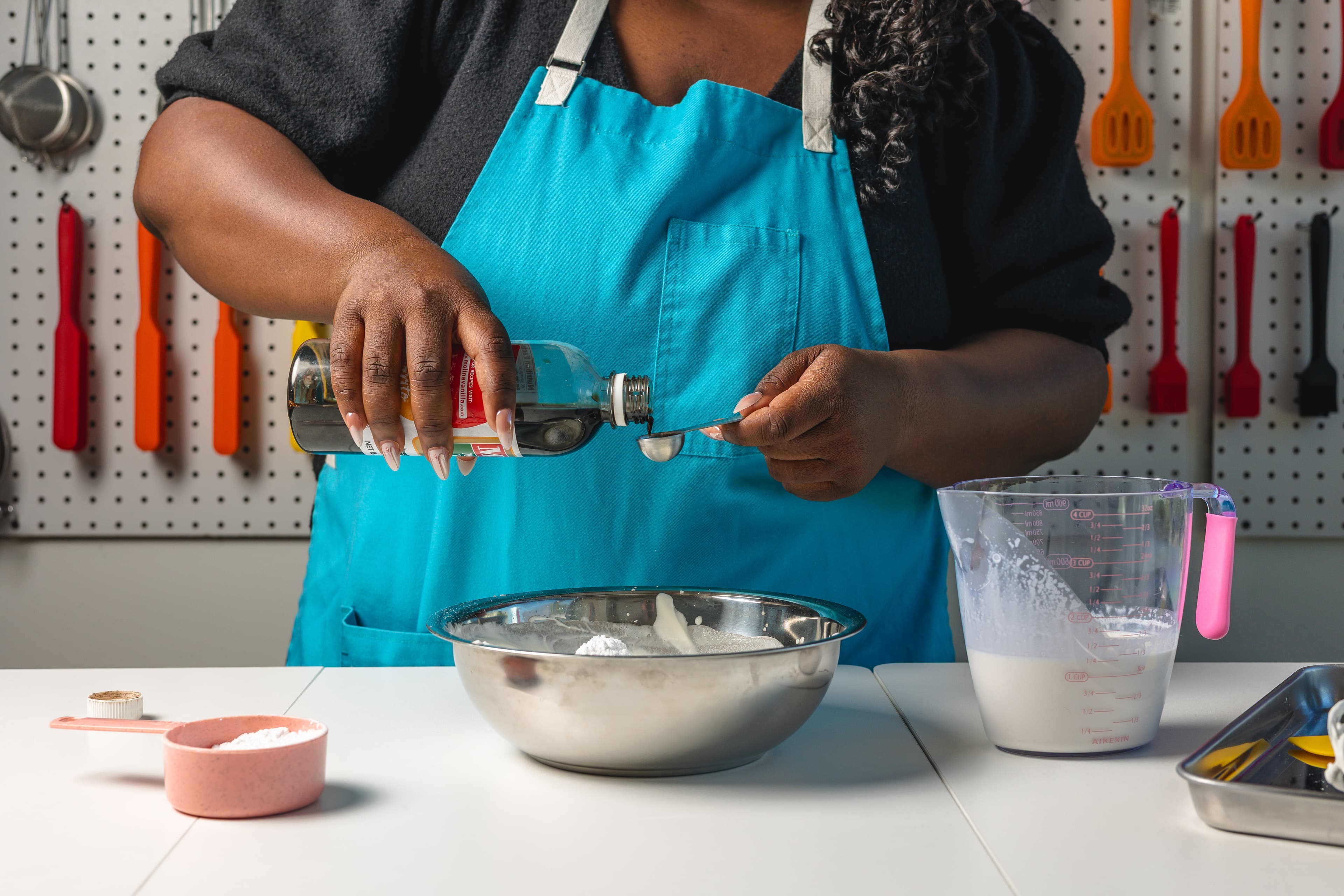 An adult participant prepares fresh ingredients during a Kind Kitchen class